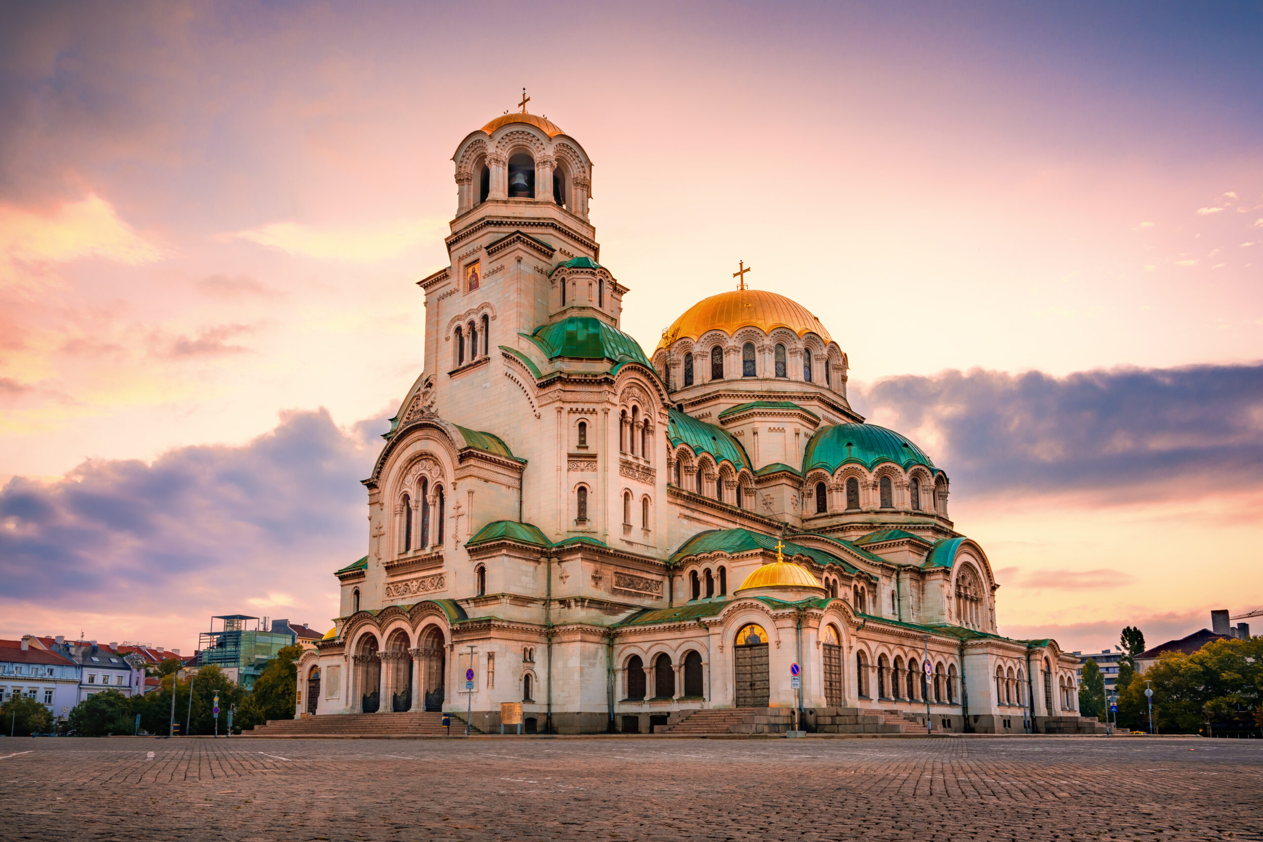 Cathedral in Bulgaria with golden domes on a square.