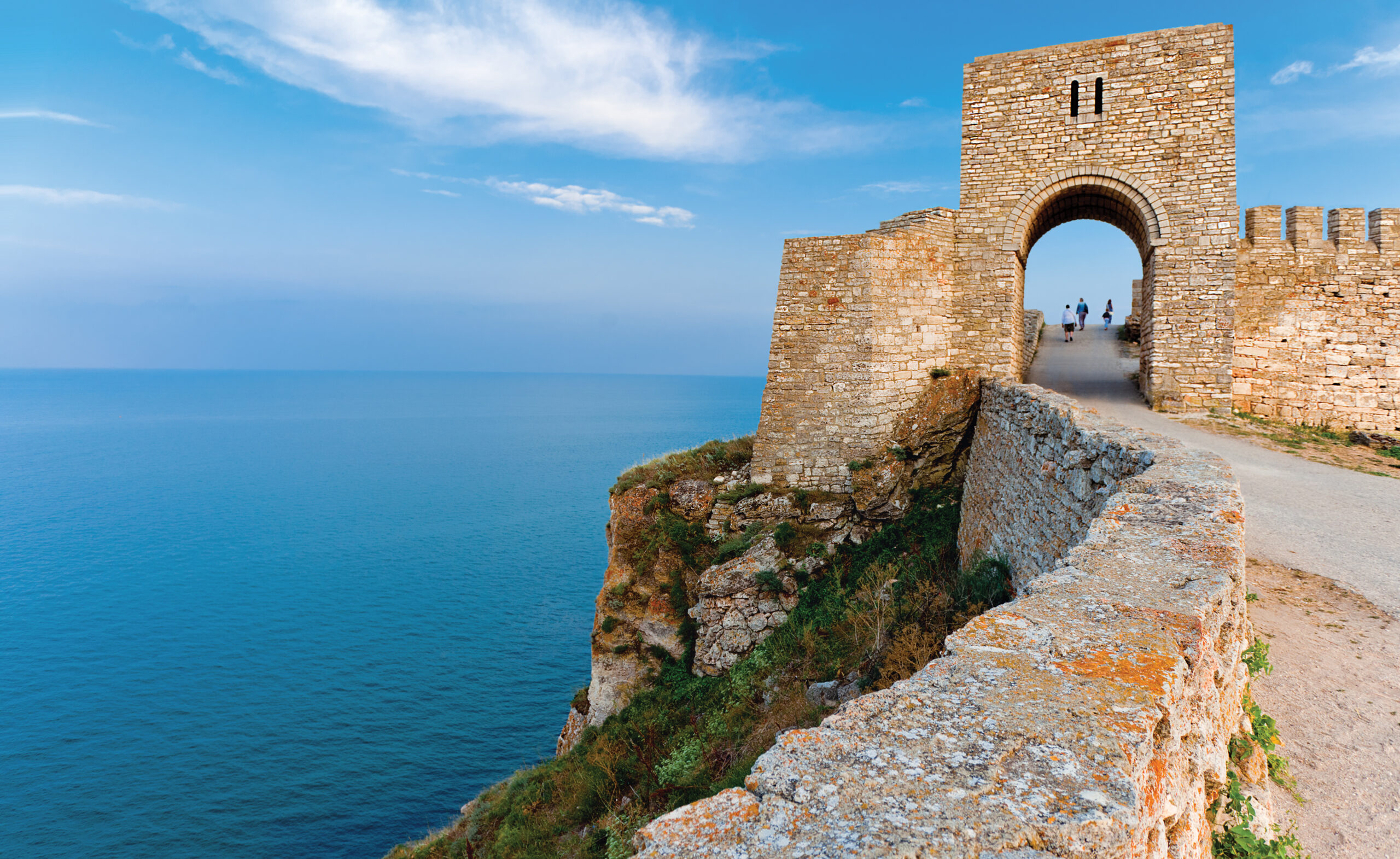 Ancient stone fortress at Bulgarian Black Sea Coast with walkway.